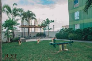 a park with ping pong tables in the grass at Centrio Tower 1BR Wifi & Netflix in Cagayan de Oro