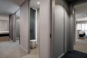 a hallway with a toilet and a room with a bedroom at Cape Town Marriott Hotel Crystal Towers in Cape Town