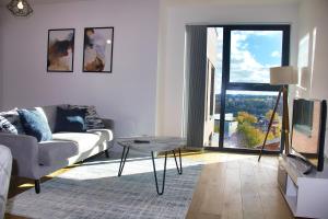 a living room with a couch and a table at AP- Luxury Apt nxt to o2 Academy in Birmingham