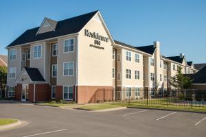 a apartment building with a sign for the institute ofmetrology at Residence Inn by Marriott Tulsa South in Tulsa