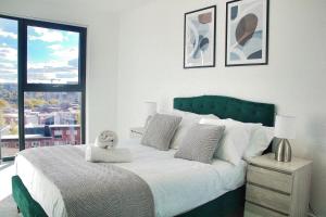 a bedroom with a large bed with a teddy bear on it at AP- Luxury Apt nxt to o2 Academy in Birmingham