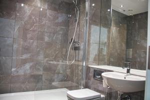 a bathroom with a shower and a toilet and a sink at AP- Luxury Apt nxt to o2 Academy in Birmingham