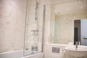 a bathroom with a shower and a sink at AP- Luxury Apt nxt to o2 Academy in Birmingham +19 photos