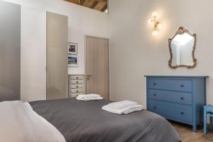a bedroom with a blue dresser and a mirror at Veronetta Stunning Rooftop with Lift in Verona