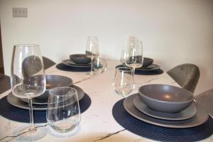 a table with plates and wine glasses on it at AP- Luxury Apt nxt to o2 Academy in Birmingham