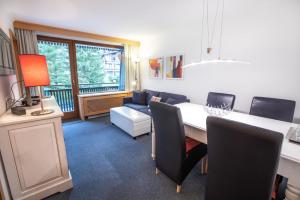 a living room with a table and chairs and a couch at Ferienwohnung Königsleiten 25 - Top 44 in Königsleiten