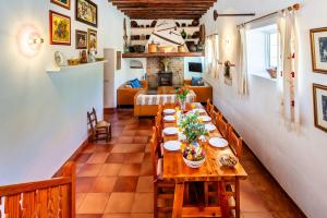 a dining room with a wooden table and chairs at New! Villa Na Ribes in Sant Carles de Peralta