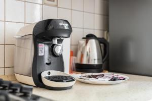 a coffee maker is sitting on a kitchen counter at Apartment Floriana Stablewskiego Poznań by Renters in Poznań