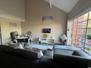 a living room with a couch and a table at Executive suite@Lofts in Pretoria