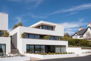 a white house with a lot of windows at 7 The Bay in Coldingham