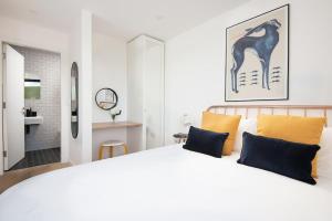 a bedroom with a large white bed and a bathroom at 7 The Bay in Coldingham