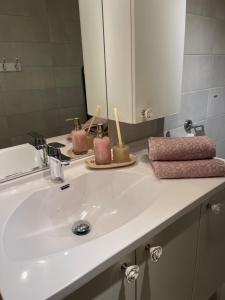 a bathroom sink with two candles sitting on it at Åskollen, Drammen in Drammen