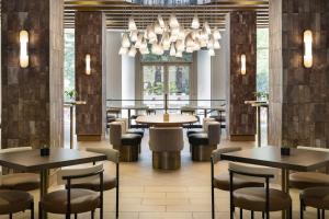 a restaurant with tables and chairs and a chandelier at San Ramon Marriott in San Ramon