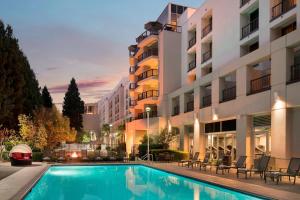 a hotel with a swimming pool in front of a building at San Ramon Marriott in San Ramon