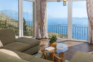 a living room with a couch and a table at Holiday Home La Montagna - Private Heated Pool in Lokva Rogoznica