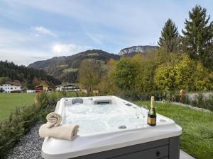a bath tub with a bottle of wine in it at Bachgeflüster in Itter
