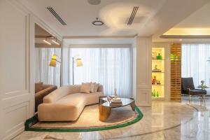 a living room with a couch and a table at The Delborough Lagos in Lagos