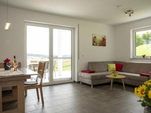 a living room with a couch and a table at Hof am Horn - Fewos in der Natur in Laichingen