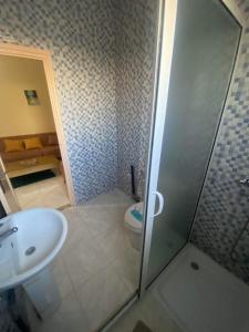a bathroom with a shower and a sink and a toilet at S+2 Corniche Nord in Bizerte