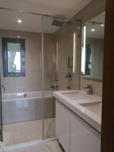 a bathroom with a tub and a sink and a shower at Altair Luxury Colombo by Miracle in Colombo