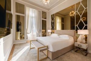a bedroom with a large white bed and a window at Grand Hotel Principe Di Piemonte in Viareggio