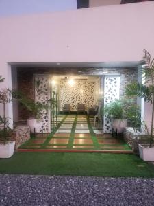 a lobby of a building with green grass at Gullivers Travel Hotel in Apenkwa