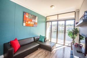 a living room with a couch and a large window at falcon crest 41, howick road, tyger waterfront, bellville in Cape Town