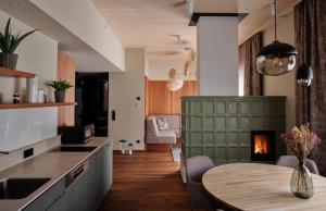 a kitchen and dining room with a table and a fireplace at Hafnerhotel - Das Kachelofen-Wohlfühlhotel in Wieselburg