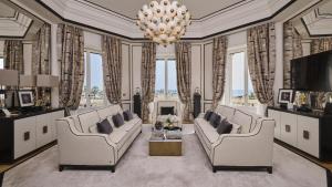 a living room with two couches and a chandelier at Grand Hotel Principe Di Piemonte in Viareggio