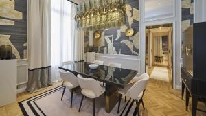 a dining room with a black table and white chairs at Grand Hotel Principe Di Piemonte in Viareggio