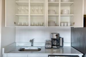 a kitchen with a sink and a coffee maker at UES 2br w elevator doorman nr transportation NYC-1297 in New York