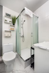 a bathroom with a shower and a toilet and a sink at Saska Kępa Comfort Apartment in Warsaw