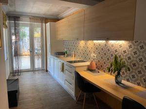 a kitchen with white cabinets and a counter top at Garden Rovinj in Rovinj