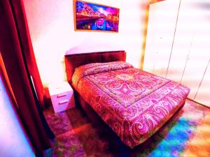 a bedroom with a bed with a purple comforter at L' appartamento sul Naviglio in Milan
