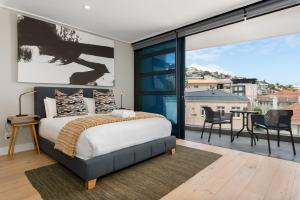 a bedroom with a bed and a large window at 7 on Bantry Apartments in Cape Town