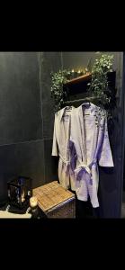 a table with a white shirt with a purple bow at Suite64 - Jacuzzi privatif in Neuilly-sur-Seine