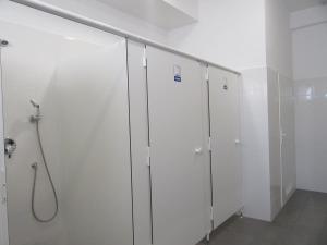 a row of white lockers in a bathroom at Szkolne Schronisko Młodzieżowe w Gdańsku School Youth Hostel in Gdańsk in Gdańsk