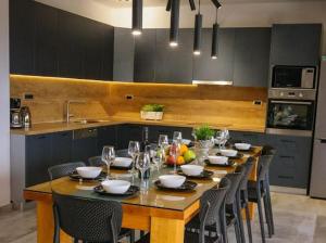a kitchen with a long wooden table with chairs at Villa Jelena in Kastel Novi