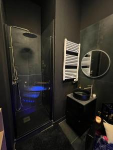 a bathroom with a shower and a sink and a mirror at Suite64 - Jacuzzi privatif in Neuilly-sur-Seine