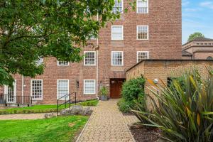 a brick building with a door in front of it at Peaceful Putney apartment by UnderTheDoormat in London