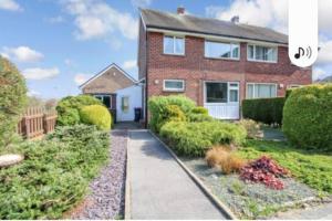 a brick house with a garden in front of it at The Rose in Greasbrough