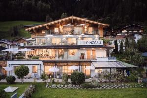 a large building with a large at Hotel Garni Pinzgau, Bernd Hüttl in Neukirchen am Großvenediger