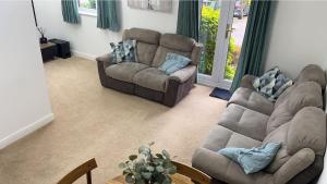 a living room with two couches and a couch at Gables in Hither Green