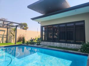 a swimming pool in front of a house at The Residence Villa in Musina