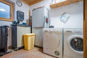 a laundry room with a washer and dryer at Chalet Schneespaß in Königsleiten