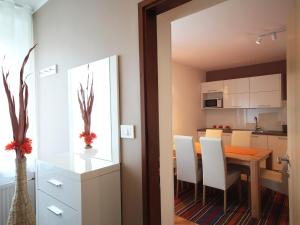 a kitchen and dining room with a table and chairs at Apartment with balcony Hiša Brdo 48 in Bovec +8 photos