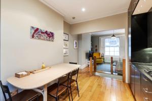 a kitchen and dining room with a table and a counter at Beautiful two-bed abode Near King Cross in London