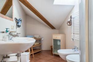 a bathroom with two sinks and a toilet at Gfinkerhof Mendel in Vols am Schlern +24 photos