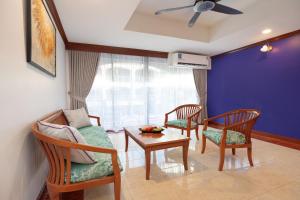 a living room with two chairs and a couch and a table at Aspira Resort Klong Muang Krabi in Klong Muang Beach