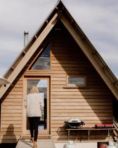 a woman is walking out of a house at Kimo Estate in Gundagai